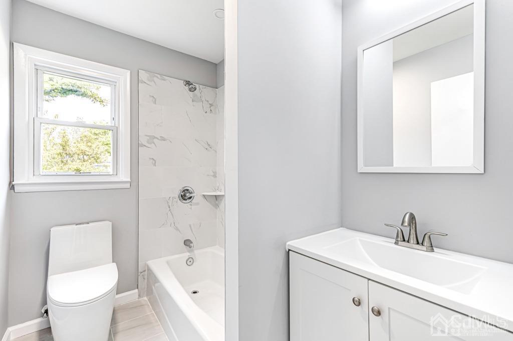 187 1st Street Middlesex, NJ 08846 - Photo 12 of 23 a bathroom with a sink toilet and shower