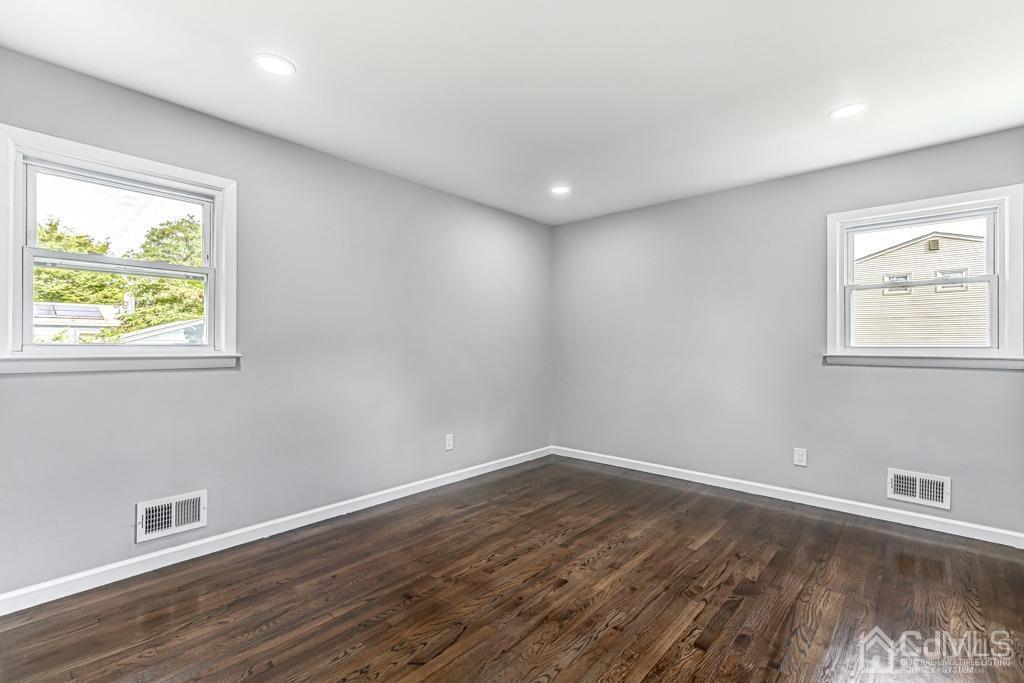 187 1st Street Middlesex, NJ 08846 - Photo 13 of 23 a view of empty room with wooden floor and fan