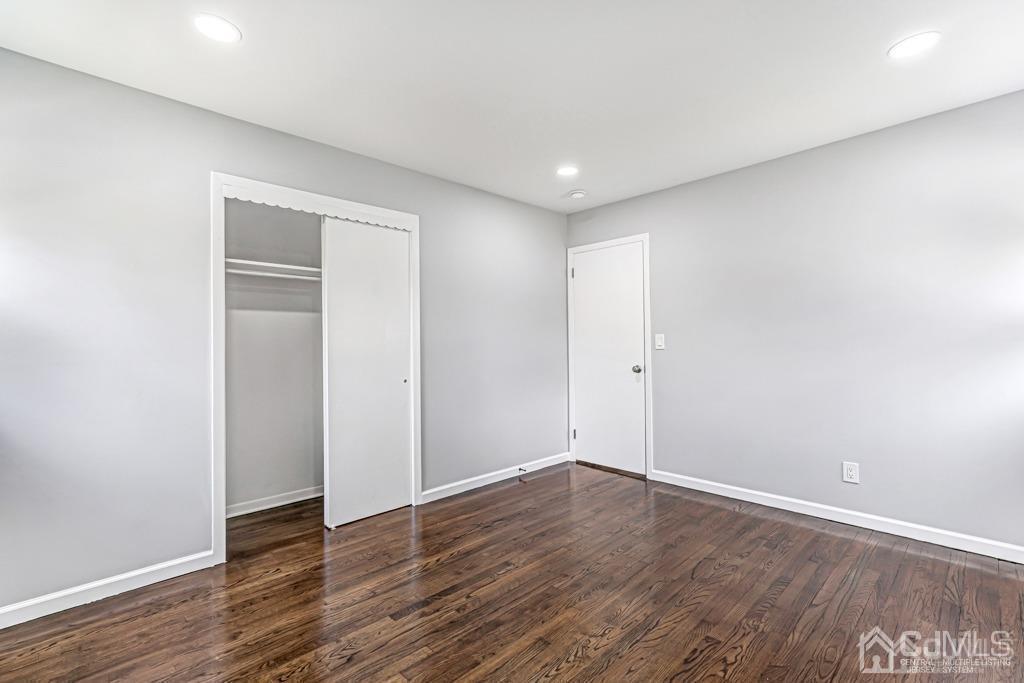 187 1st Street Middlesex, NJ 08846 - Photo 14 of 23 a view of an empty room with wooden floor