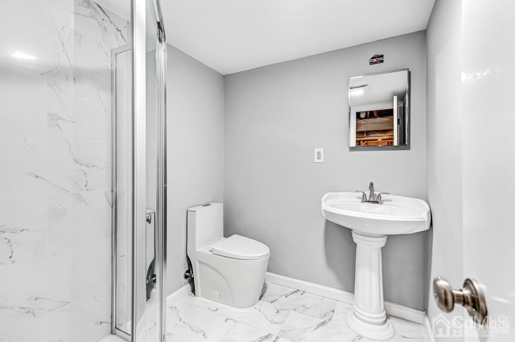 187 1st Street Middlesex, NJ 08846 - Photo 17 of 23 a bathroom with a sink toilet and a mirror