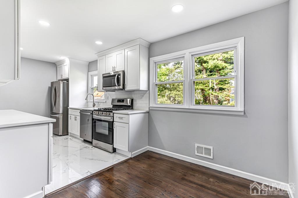 187 1st Street Middlesex, NJ 08846 - Photo 7 of 23 a kitchen with a refrigerator and a stove top oven