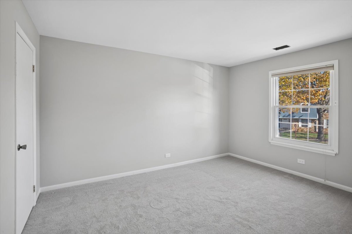 220 Hawthorne Court, Unit B2 Schaumburg, IL 60193 - Photo 15 of 20 a view of an empty room with a window