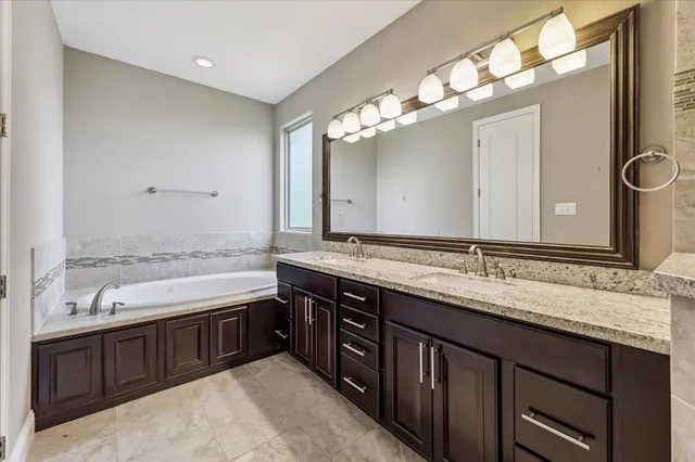 a bathroom with a sink double vanity and a mirror
