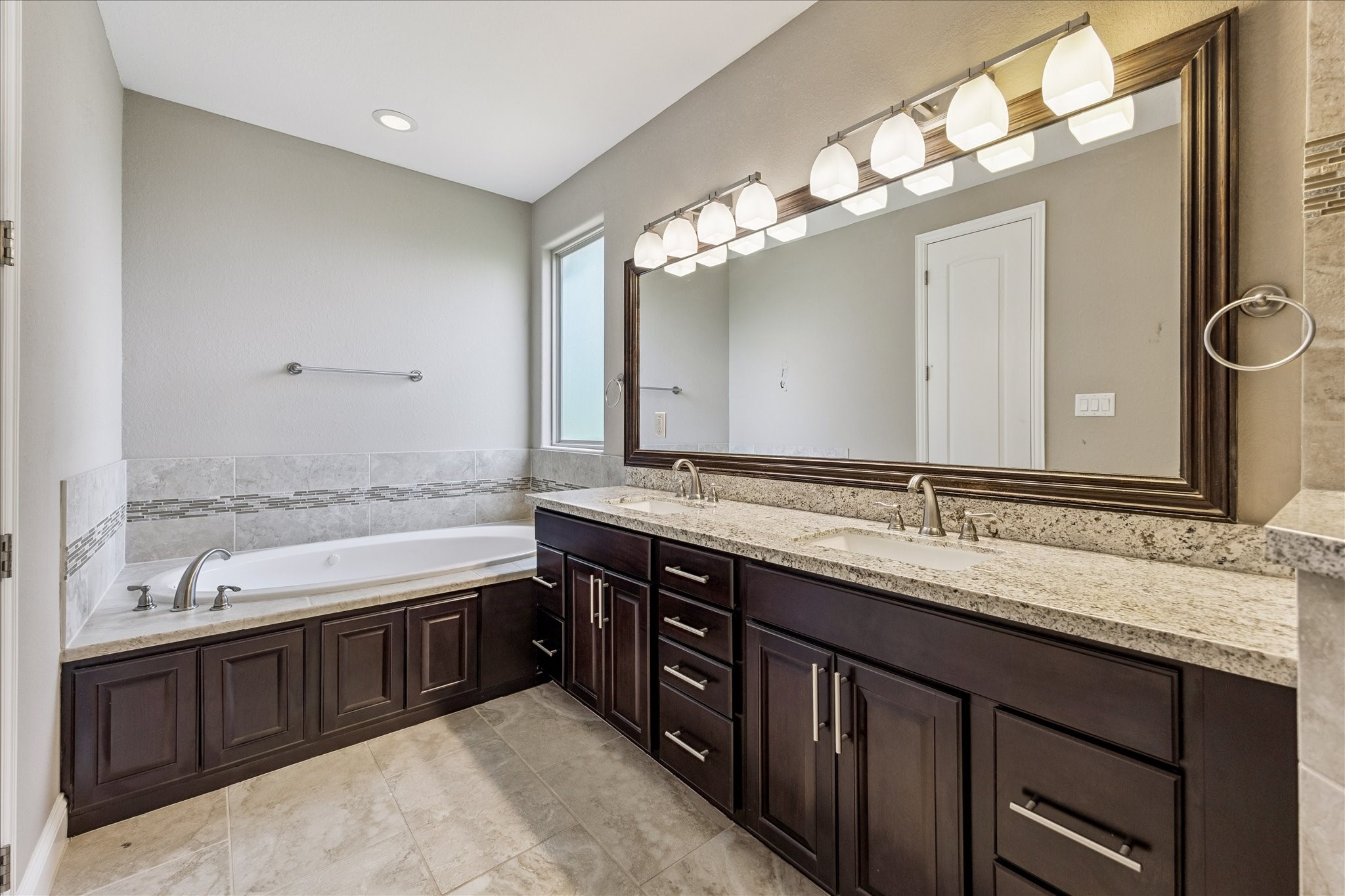 1113 West 18th Street, Unit B Houston, TX 77008 - Photo 24 of 32 a bathroom with a granite countertop double vanity and a large mirror