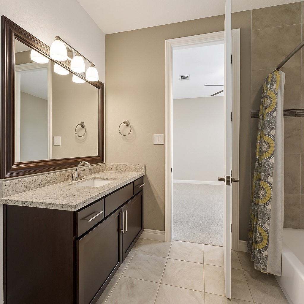 1113 West 18th Street, Unit B Houston, TX 77008 - Photo 29 of 32 a bathroom with a granite countertop sink and a mirror
