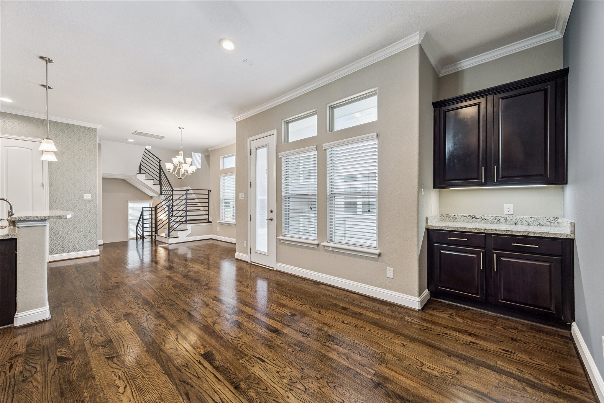 1113 West 18th Street, Unit B Houston, TX 77008 - Photo 9 of 32 a view of an empty room with a kitchen and wooden floor