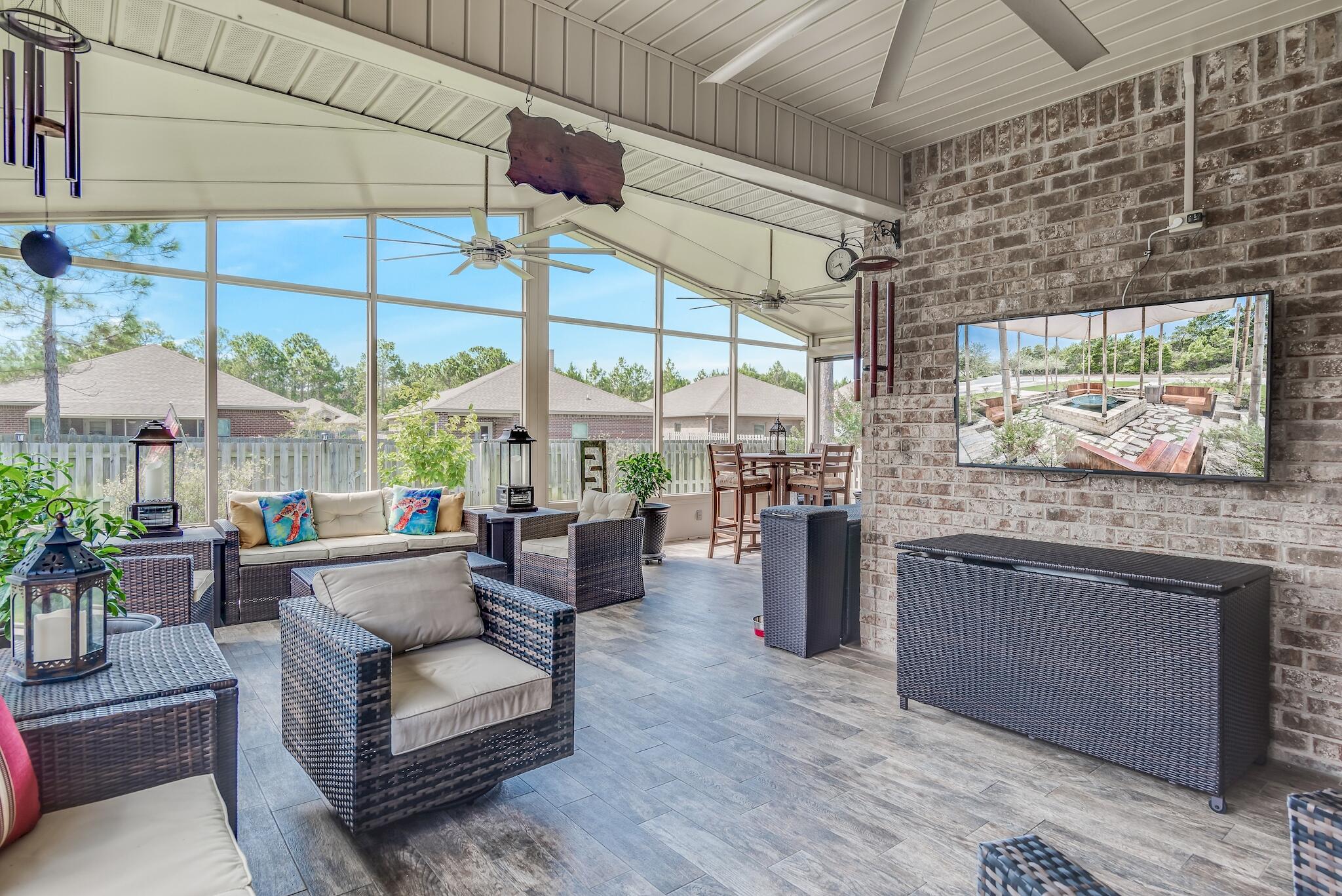 446 Pin Oak Loop Santa Rosa Beach, FL 32459 - Photo 13 of 48 a living room with furniture large windows and wooden floor
