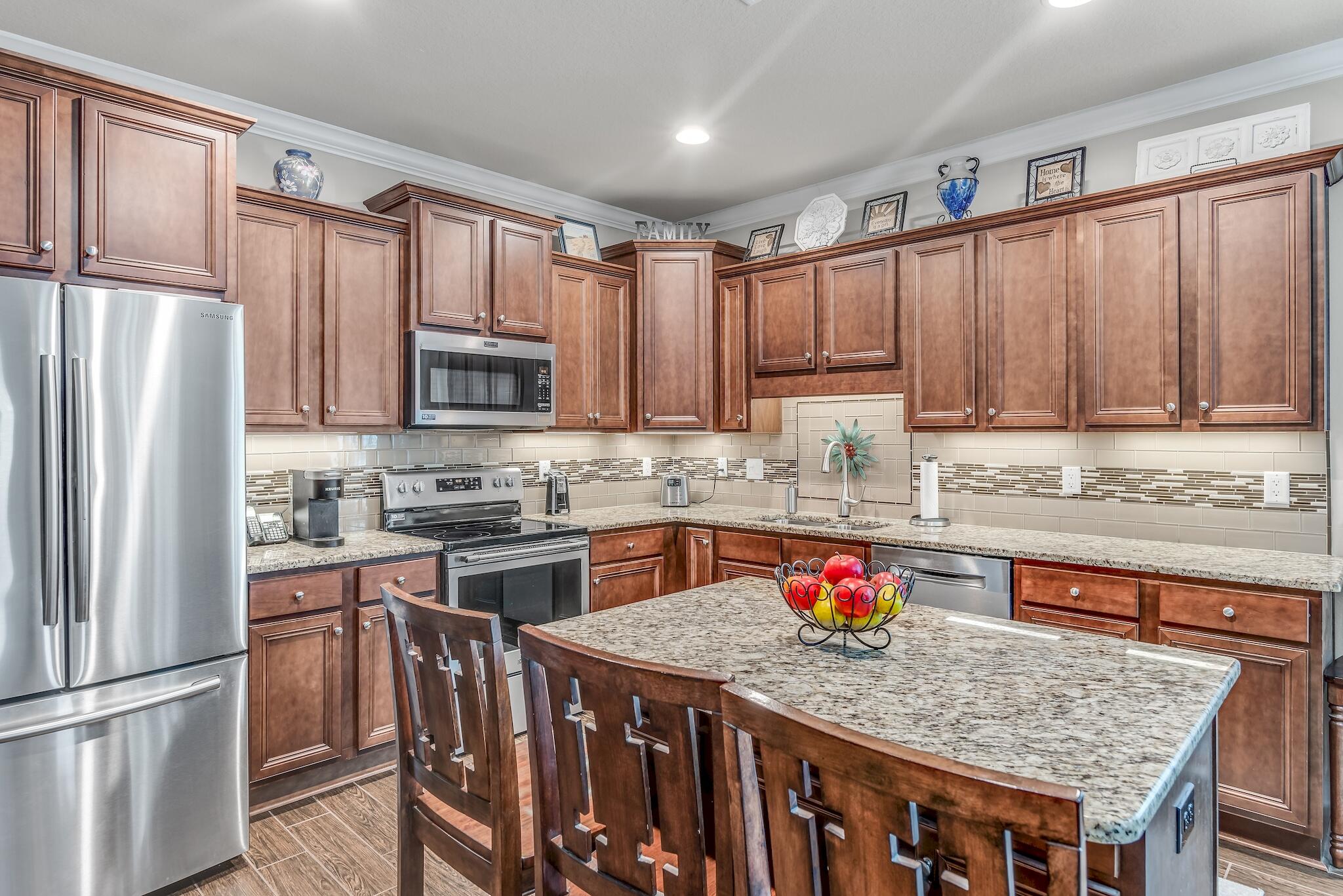 446 Pin Oak Loop Santa Rosa Beach, FL 32459 - Photo 20 of 48 a kitchen with stainless steel appliances granite countertop a refrigerator sink microwave and cabinets