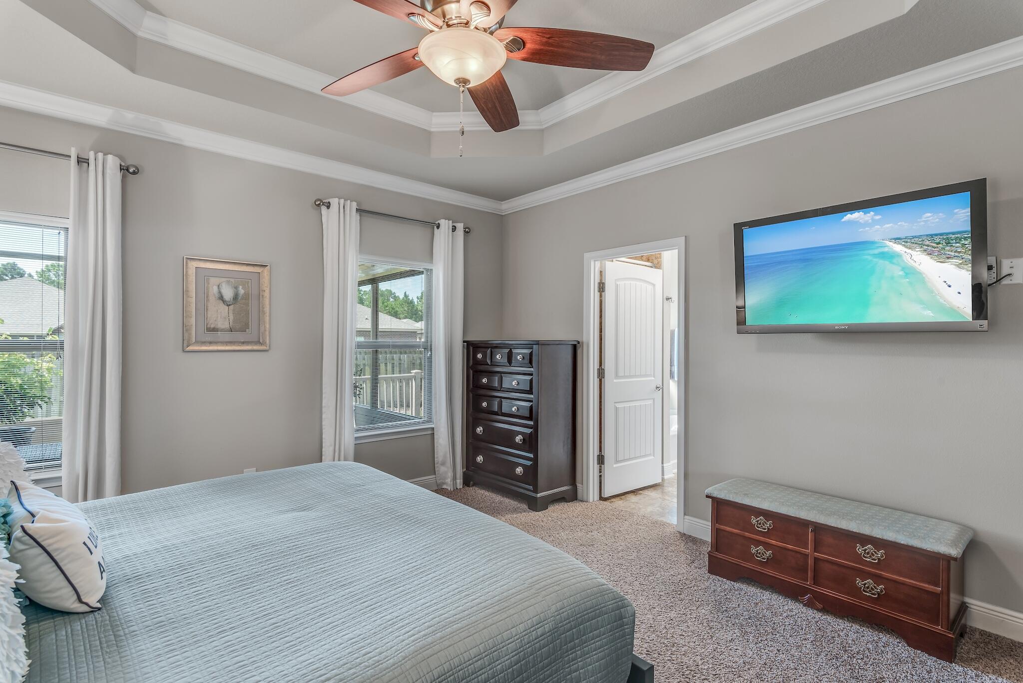 446 Pin Oak Loop Santa Rosa Beach, FL 32459 - Photo 24 of 48 a bedroom with a bed and a chandelier