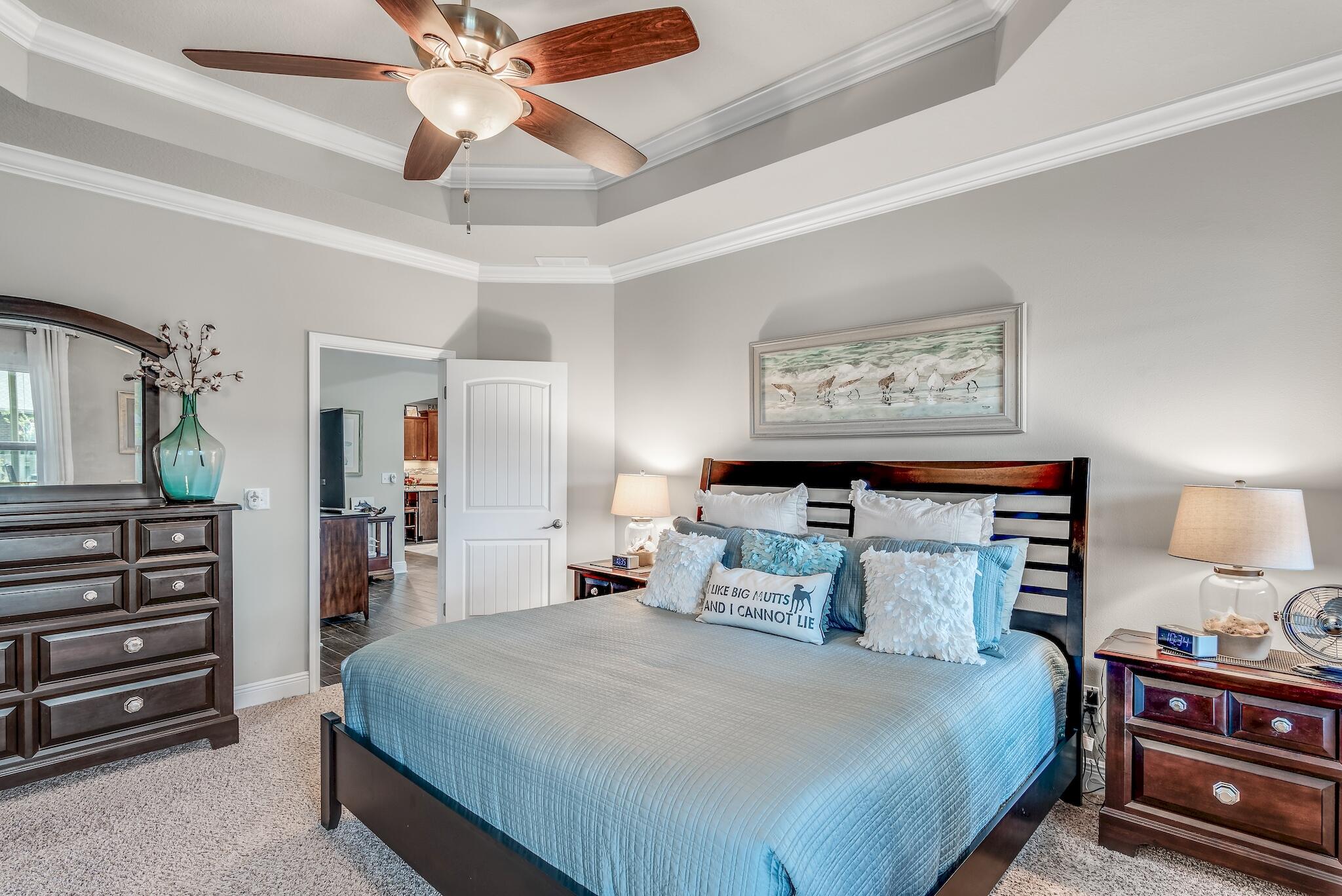 446 Pin Oak Loop Santa Rosa Beach, FL 32459 - Photo 25 of 48 a bedroom with a bed and a chandelier