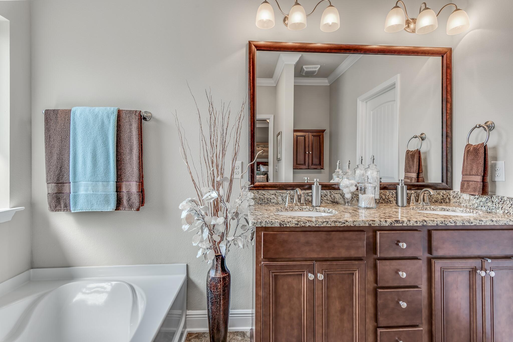 446 Pin Oak Loop Santa Rosa Beach, FL 32459 - Photo 26 of 48 a bathroom with a granite countertop sink and a mirror