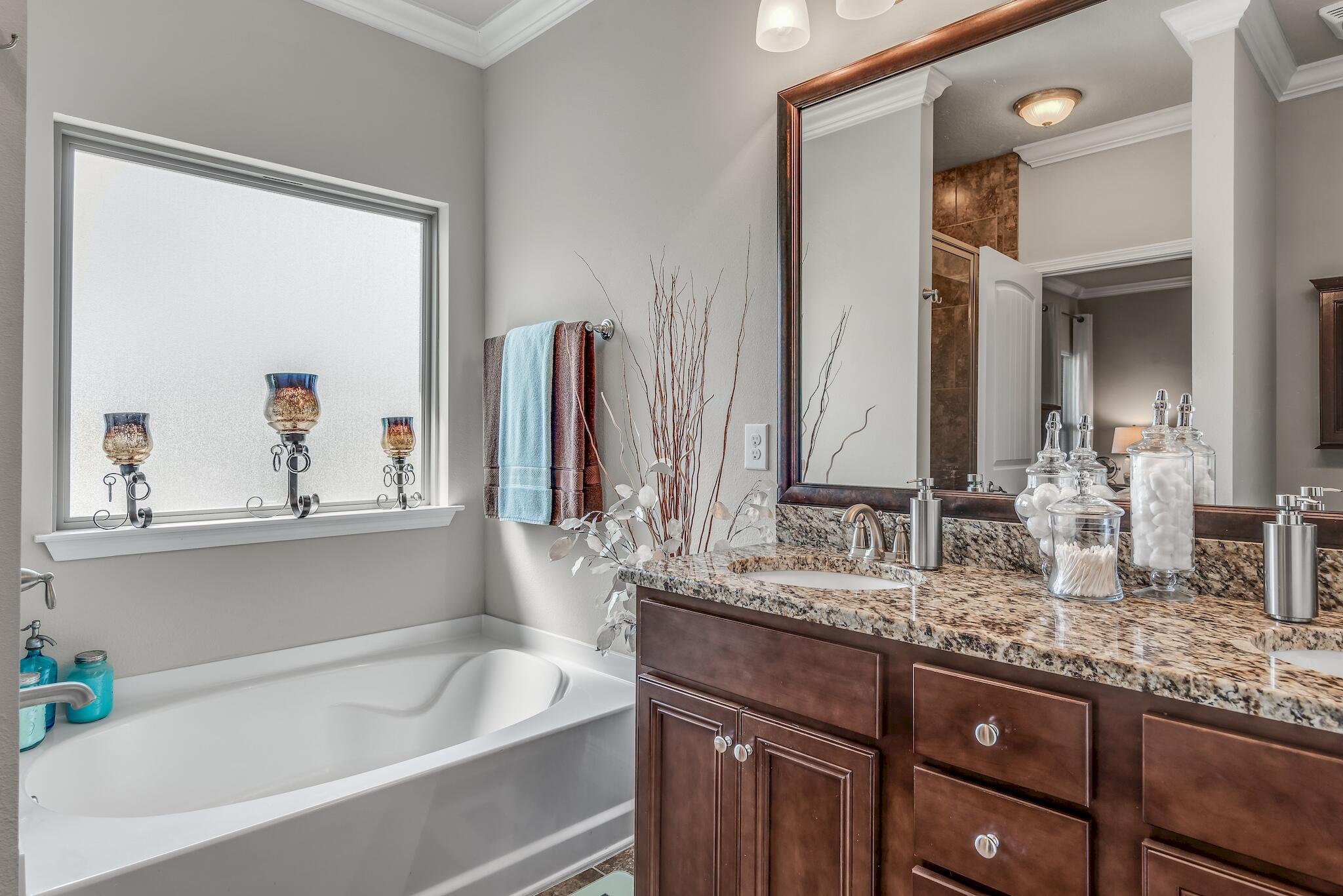 446 Pin Oak Loop Santa Rosa Beach, FL 32459 - Photo 27 of 48 a bathroom with a granite countertop sink and a bathtub