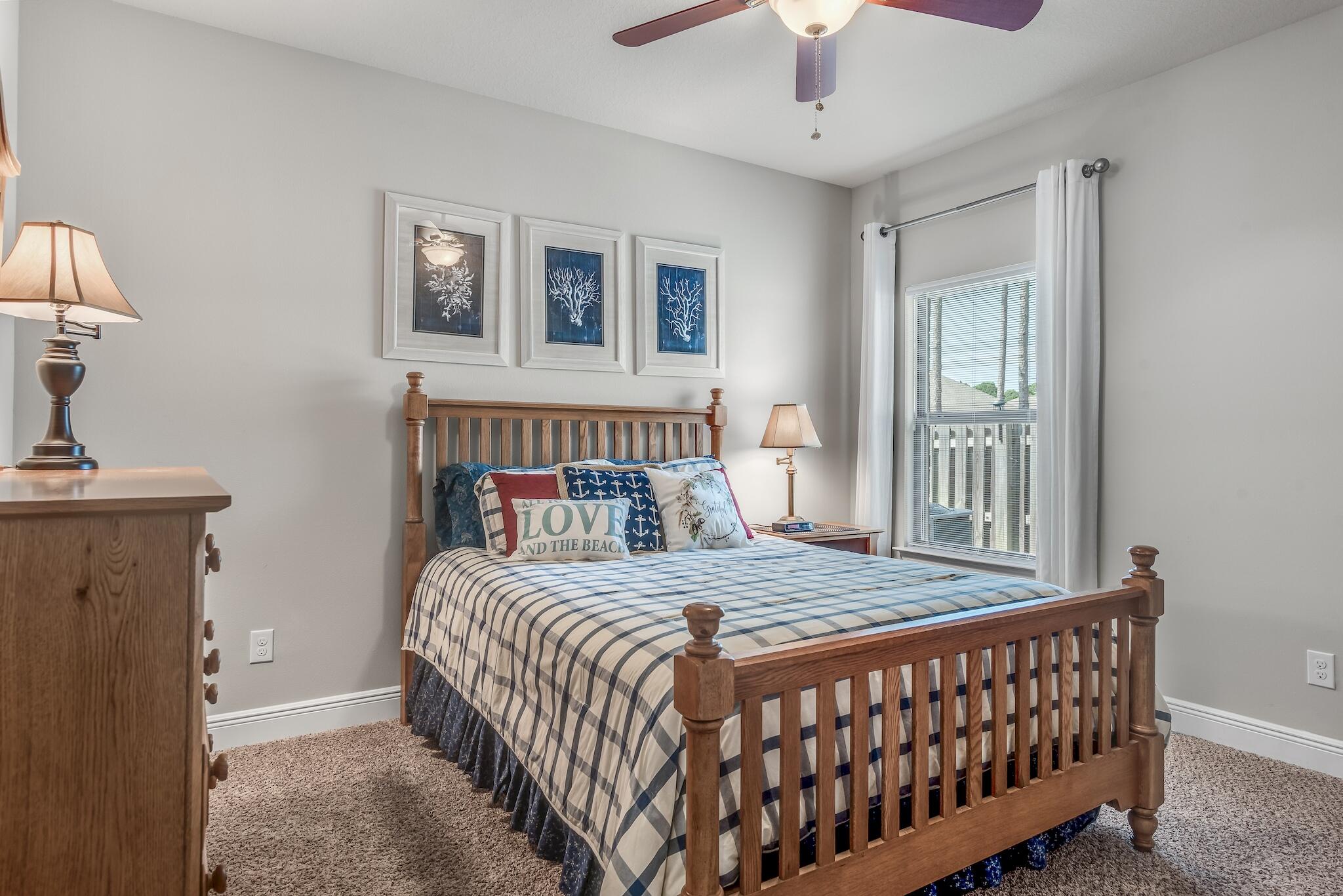 446 Pin Oak Loop Santa Rosa Beach, FL 32459 - Photo 29 of 48 a bedroom with a bed and a chandelier