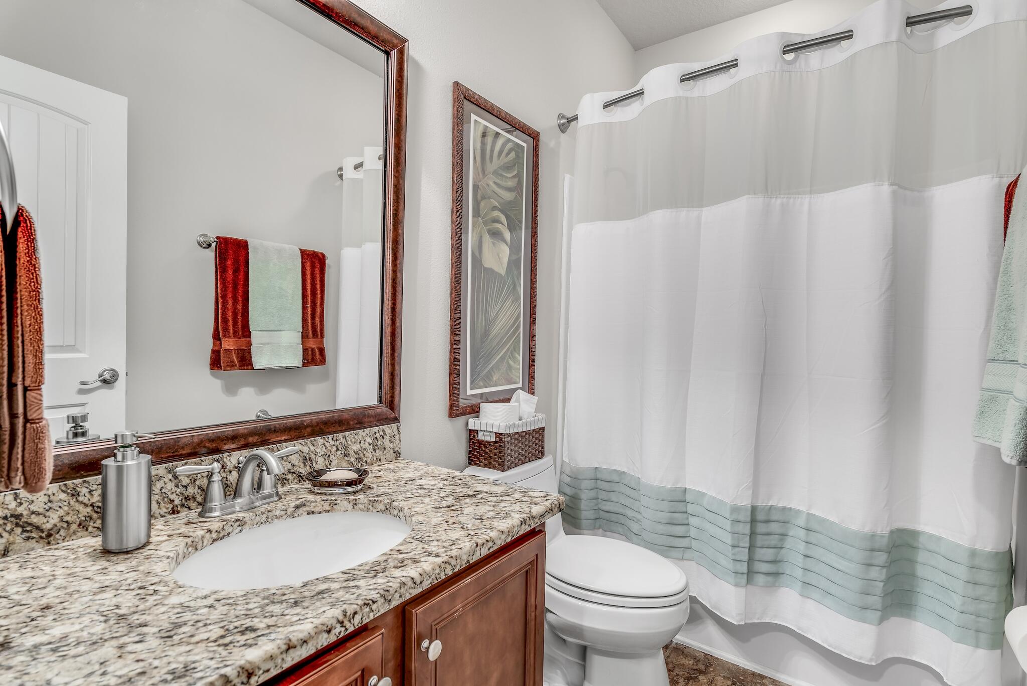 446 Pin Oak Loop Santa Rosa Beach, FL 32459 - Photo 31 of 48 a bathroom with a granite countertop sink and a mirror