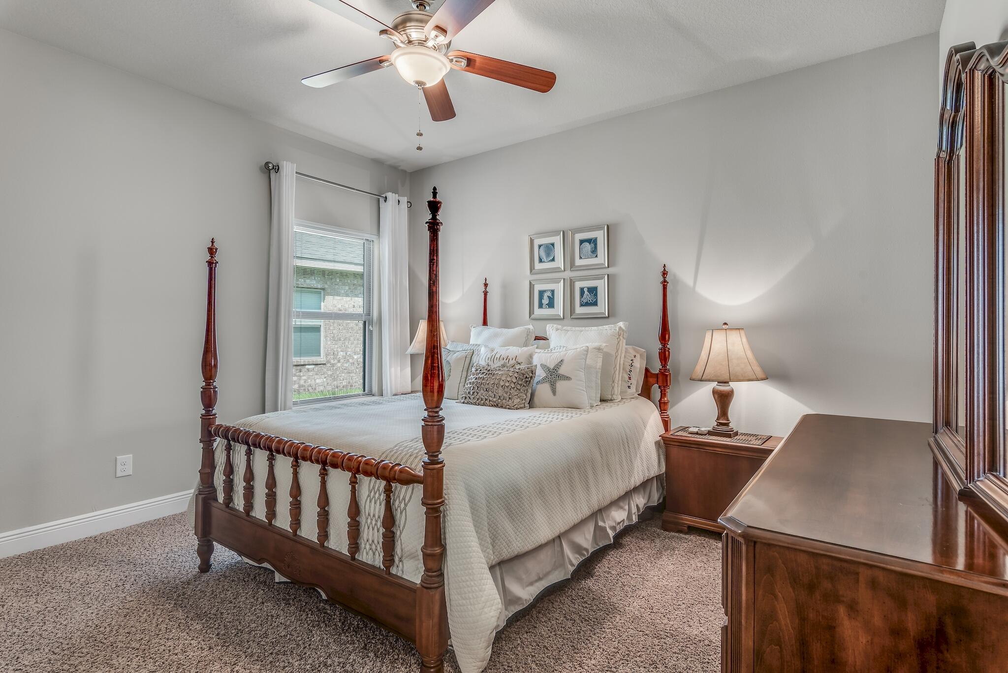 446 Pin Oak Loop Santa Rosa Beach, FL 32459 - Photo 32 of 48 a bedroom with a bed and a chandelier