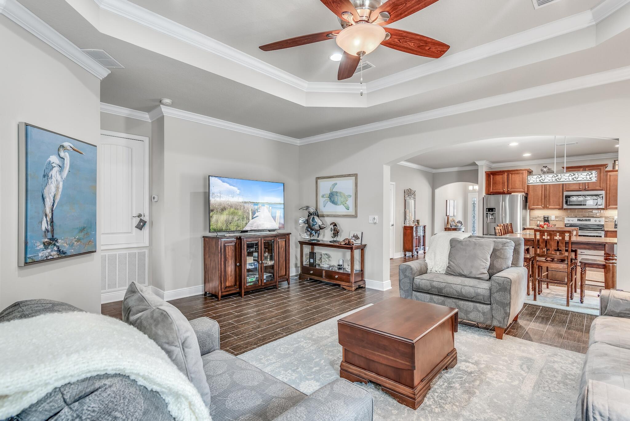 446 Pin Oak Loop Santa Rosa Beach, FL 32459 - Photo 6 of 48 a living room with furniture and a dining table with wooden floor