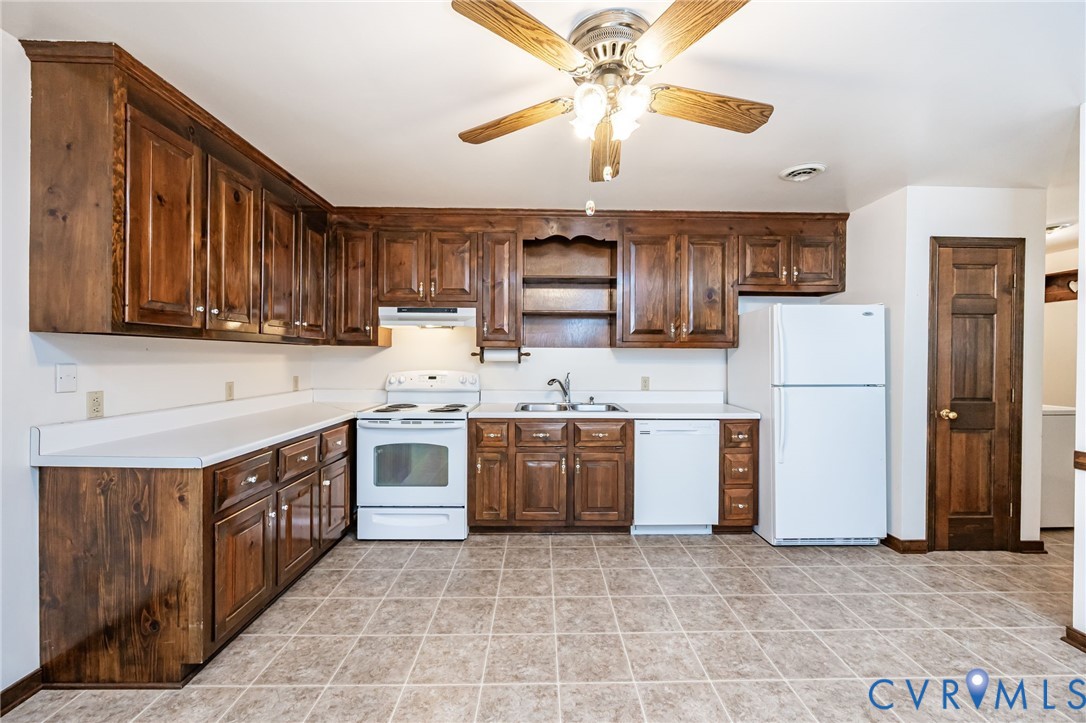 8401 Beaver Bridge Road Moseley, VA 23120 - Photo 12 of 34 a kitchen with stainless steel appliances granite countertop a stove top oven a refrigerator a sink and dishwasher