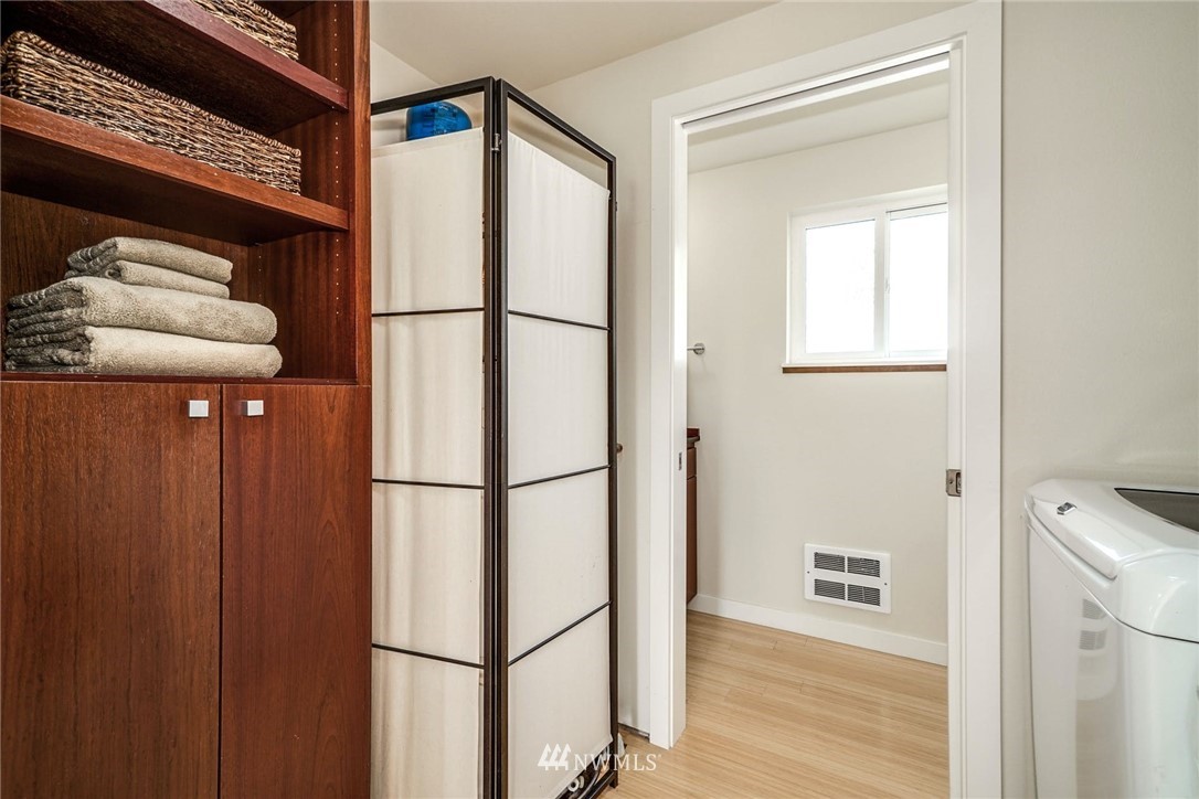 5409 26th Avenue Southwest, Unit B Seattle, WA 98106 - Photo 14 of 31 a white refrigerator freezer and a wooden floor