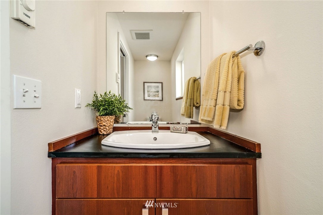 5409 26th Avenue Southwest, Unit B Seattle, WA 98106 - Photo 15 of 31 a bathroom with a sink and a mirror