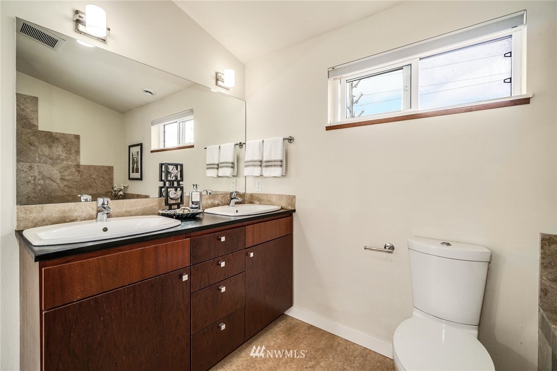 5409 26th Avenue Southwest, Unit B Seattle, WA 98106 - Photo 20 of 31 a bathroom with a toilet sink and mirror