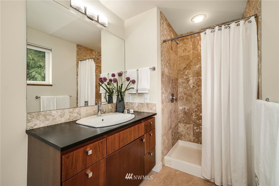 5409 26th Avenue Southwest, Unit B Seattle, WA 98106 - Photo 23 of 31 a bathroom with a sink and a mirror