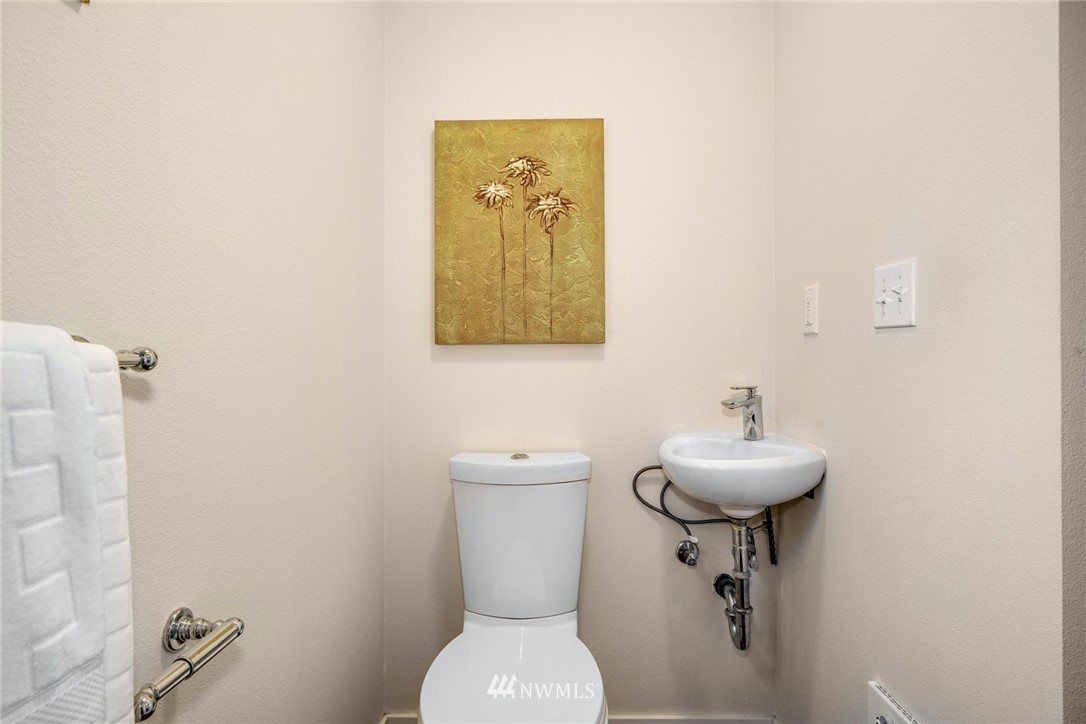 5409 26th Avenue Southwest, Unit B Seattle, WA 98106 - Photo 26 of 31 a bathroom with a toilet sink and mirror