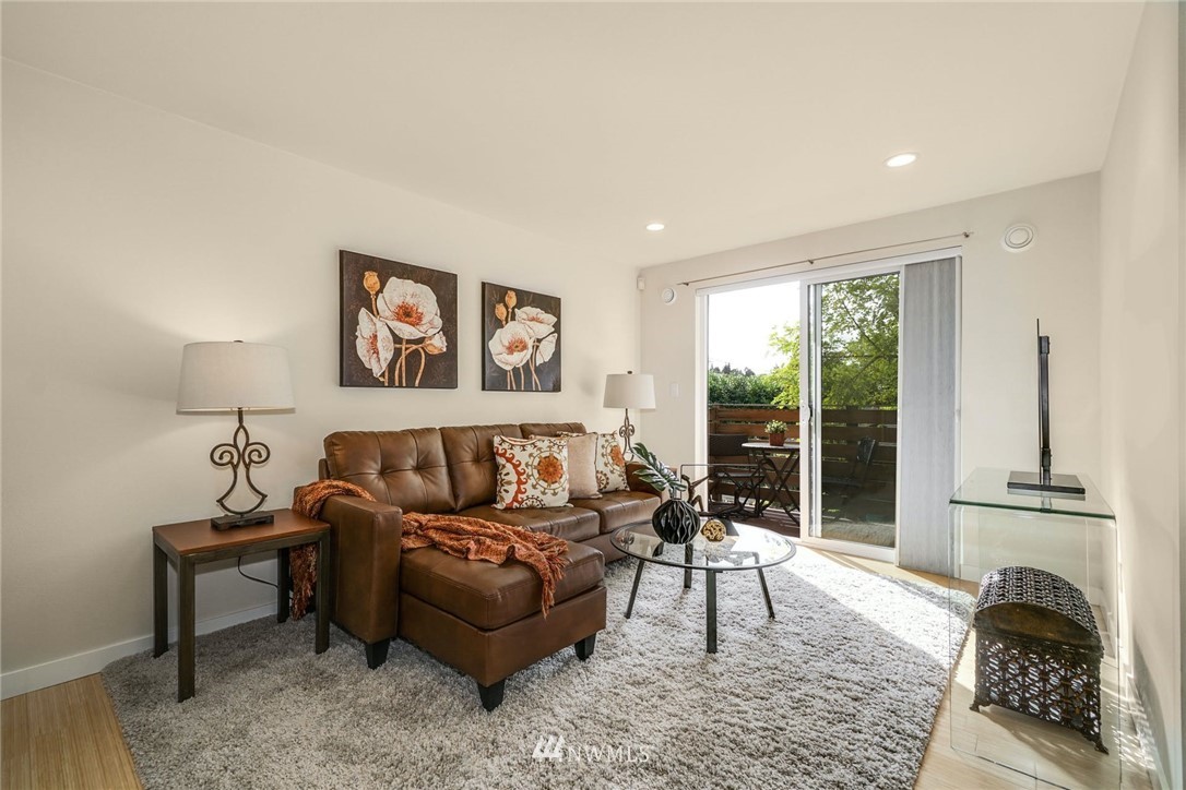 5409 26th Avenue Southwest, Unit B Seattle, WA 98106 - Photo 4 of 31 a living room with furniture and a floor to ceiling window