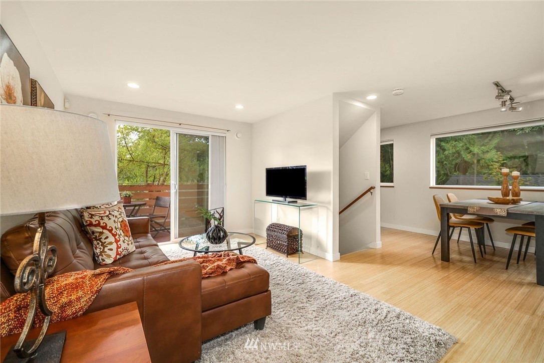 5409 26th Avenue Southwest, Unit B Seattle, WA 98106 - Photo 7 of 31 a living room with furniture a flat screen tv and a large window