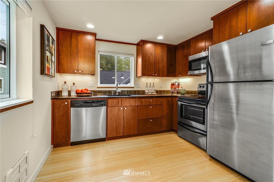 5409 26th Avenue Southwest, Unit B Seattle, WA 98106 - Photo 9 of 31 a kitchen with stainless steel appliances a refrigerator sink and cabinets