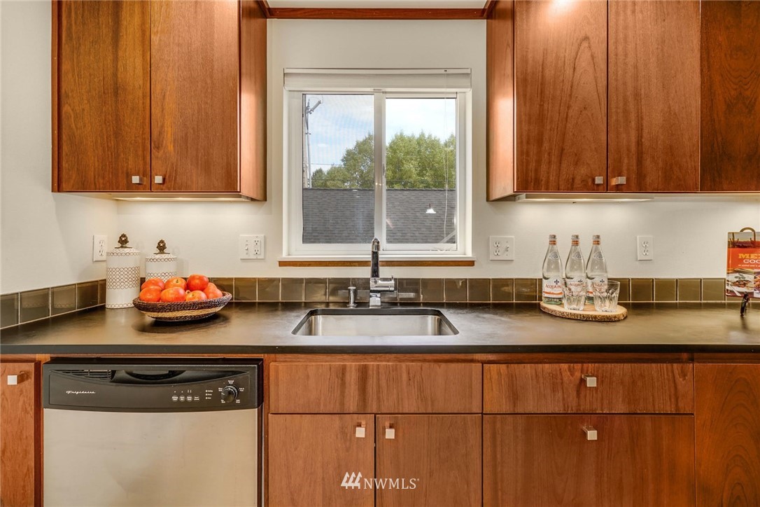 5409 26th Avenue Southwest, Unit B Seattle, WA 98106 - Photo 10 of 31 a kitchen with granite countertop cabinets and window
