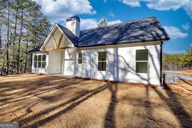 a view of a house with a yard and potted plants