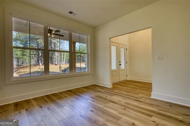 a kitchen with stainless steel appliances granite countertop white cabinets and a sink