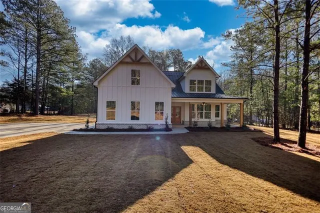 a view of a house with a yard covered in snow