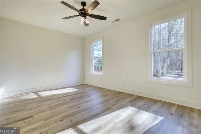 a living room with furniture a rug and a flat screen tv