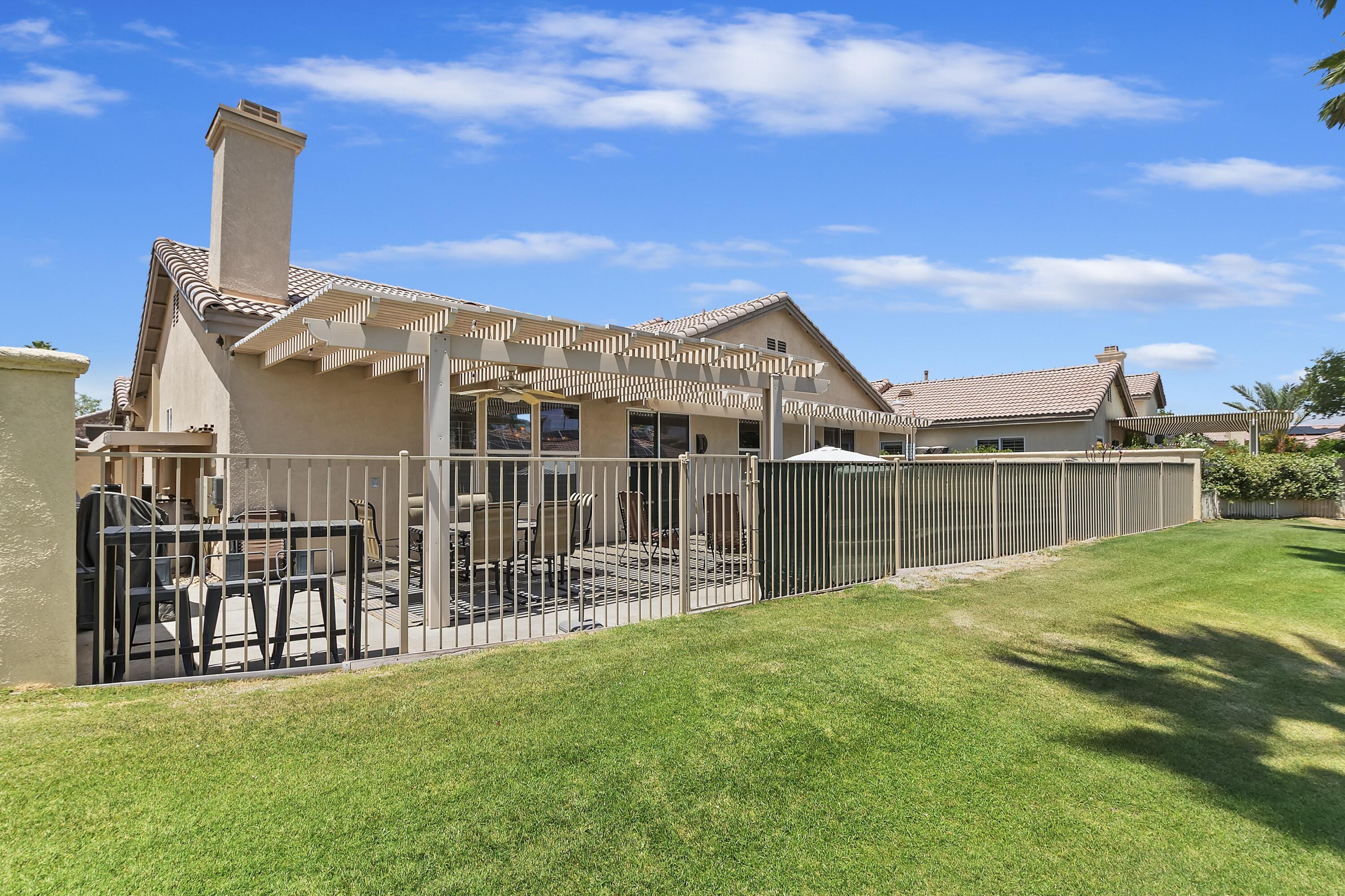 49714 Newman Circle Indio, CA 92201 - Photo 16 of 19 a view of a house with a yard