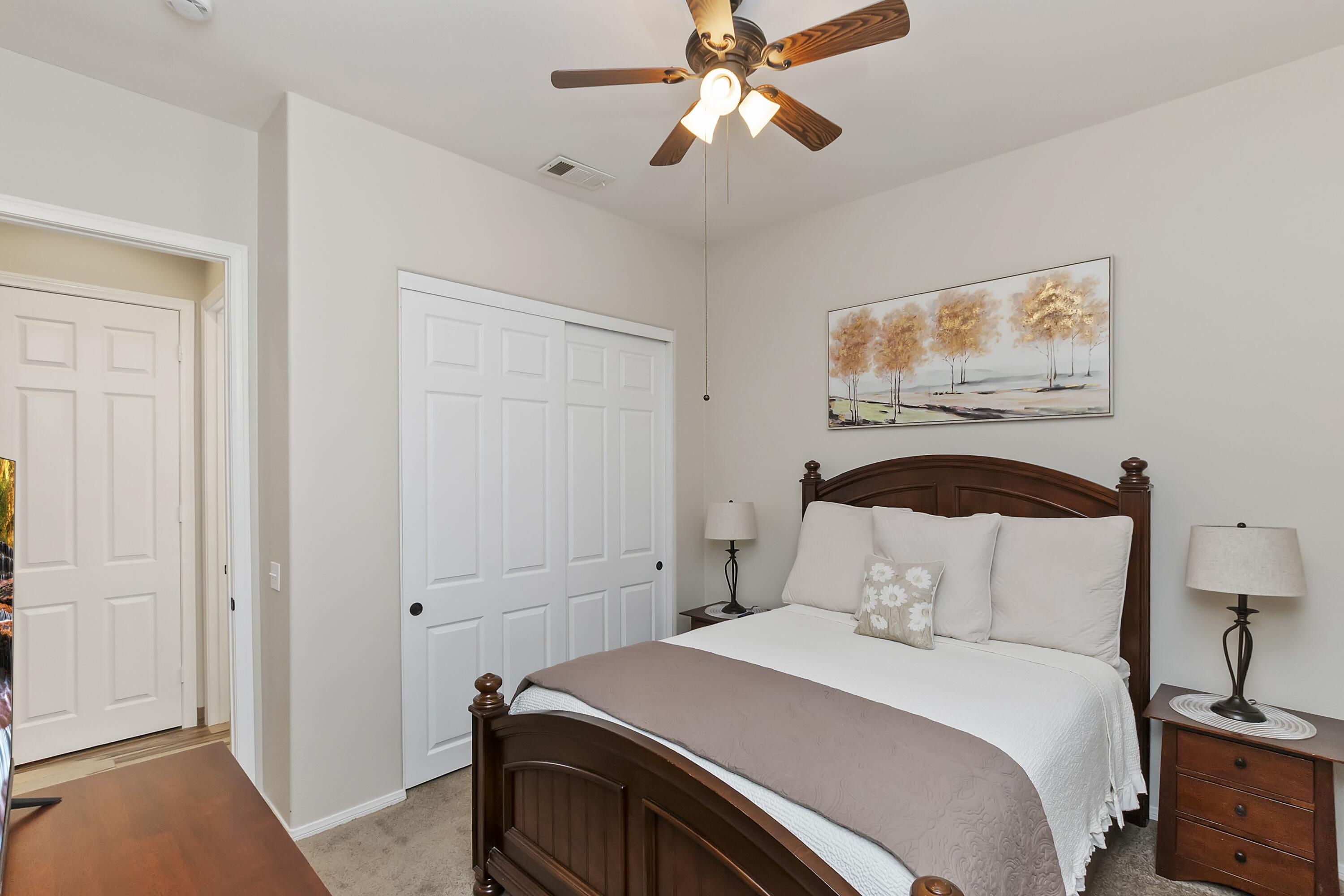 49714 Newman Circle Indio, CA 92201 - Photo 9 of 19 a bedroom with a bed and a chandelier