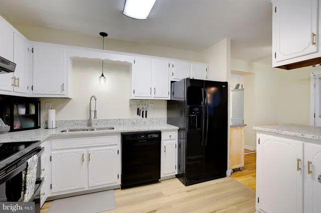 a kitchen with a sink and a refrigerator