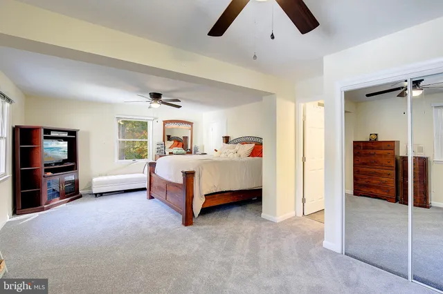 a spacious bedroom with a bed and a large walk in closet
