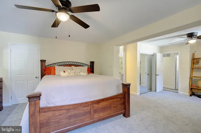 a bedroom with a bed and a ceiling fan