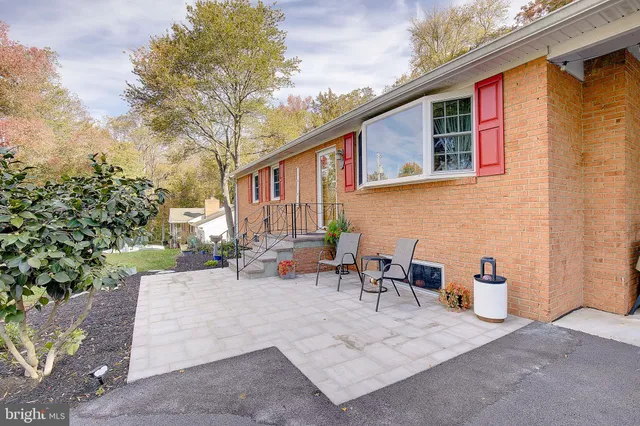 a view of a patio with table and chairs and potted plants