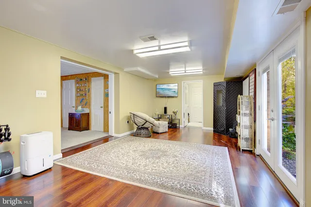 a living room with furniture a fireplace and a large window