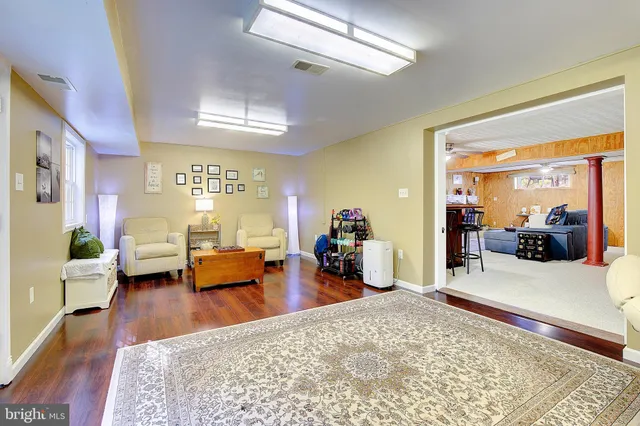 a bedroom with furniture and a wooden floor