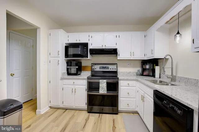 a kitchen with stainless steel appliances granite countertop a stove and a sink