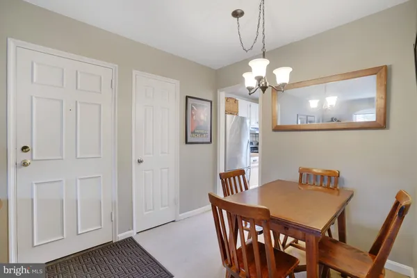 a living room with furniture and painting on the wall