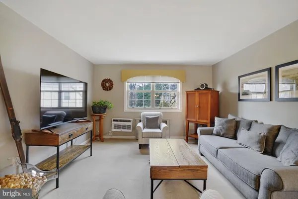 a living room with furniture and a large mirror