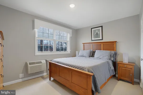 a bedroom with a bed and painting on the wall