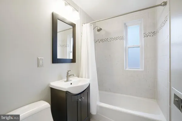 a bathroom with a sink a mirror and a bathtub