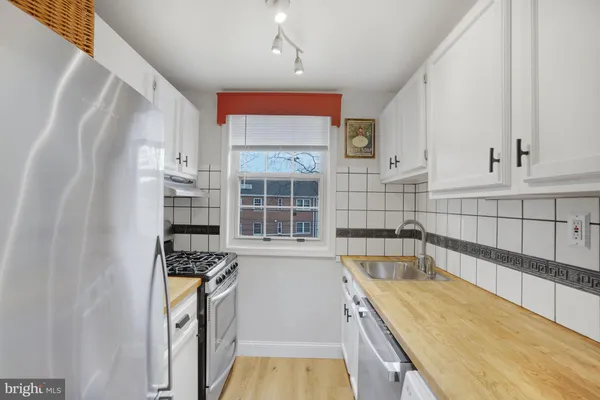 a kitchen with granite countertop a sink and a stove top oven