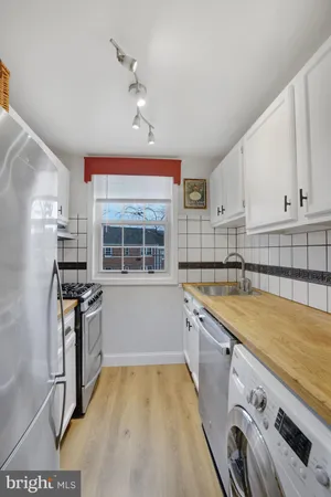a kitchen with a sink stove and refrigerator