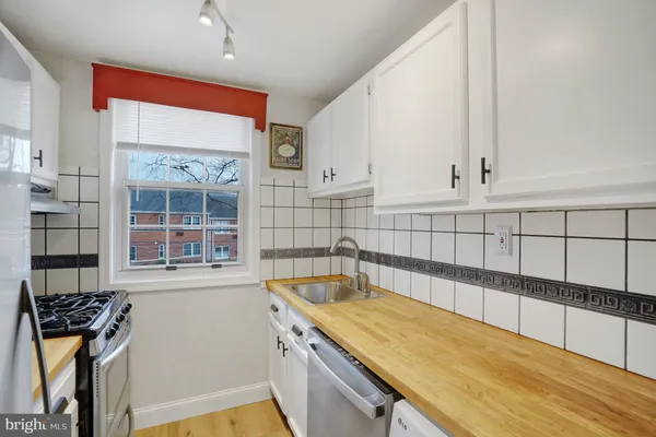 a view of a kitchen with a sink and cabinets